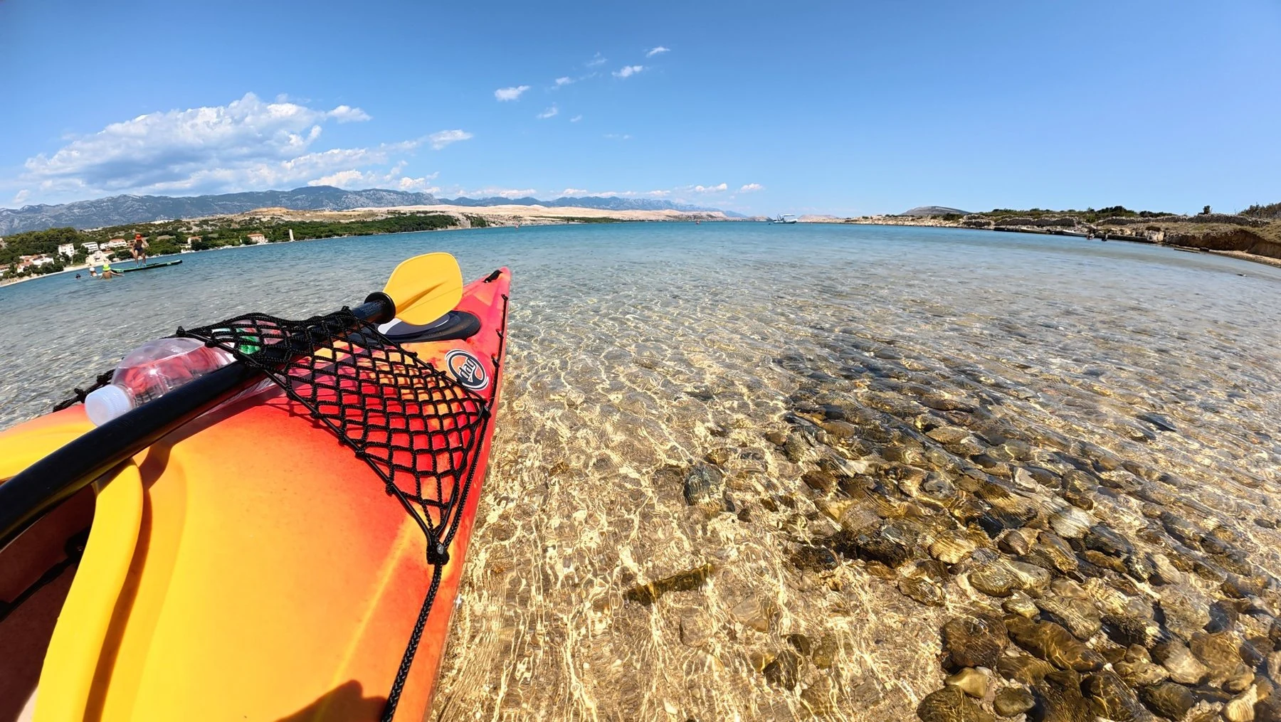 Kayak beside crystal-clear water on Pag Island